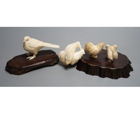 A Japanese Meiji period ivory bird with mother of pearl eyes, a Japanese group of three chickens and Japanese copulating chic