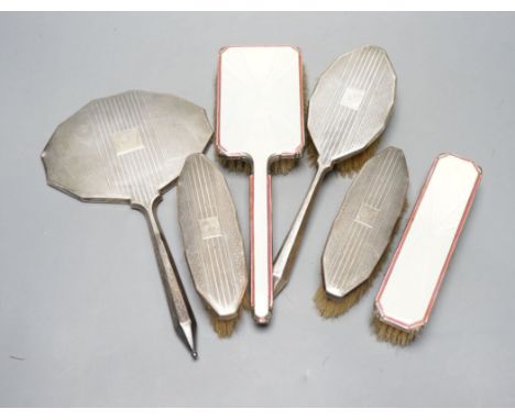 Two 1950's silver and enamel mounted brushes and an earlier four piece silver mounted brush set.