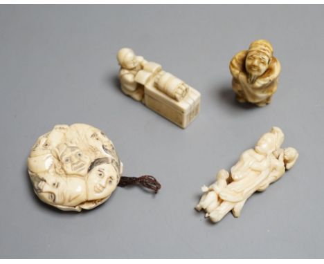 A Japanese ivory netsuke of a man reading a book, a small okimono of Guanyin and monkeys, a Manju netsuke of masks and an ear