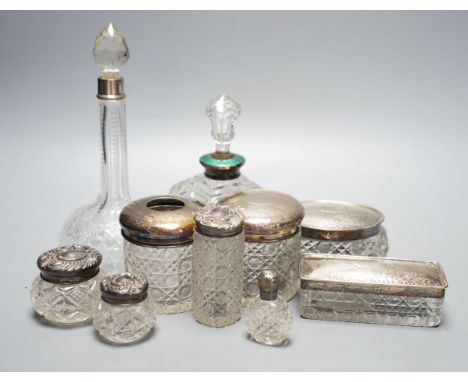 Two silver mounted cut glass scent bottles, including enamel(a.f.) and eight various dressing table items with silver lids.