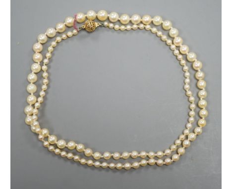 A singe strand graduated cultured pearl necklace with yellow metal clasp, 64cm, gross weight 20.3 grams.