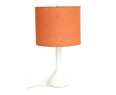 Kastrup Glas, Denmark A table lamp with white opaline glass base and orange fabric shade, 1960s, marked with label. 50 cm. h.
