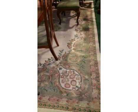 An Indian Wool Carpet with White Ground; with floral medallion centre within running borders, 400 x 270 cm approx.