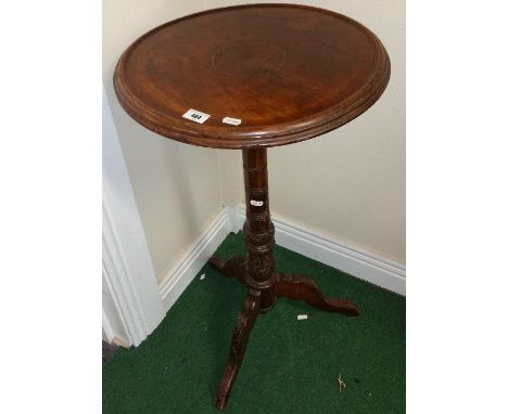 A 19th Century Mahogany Tripod Table with moulded edge and raised rim, on highly carved supports. 29in high.