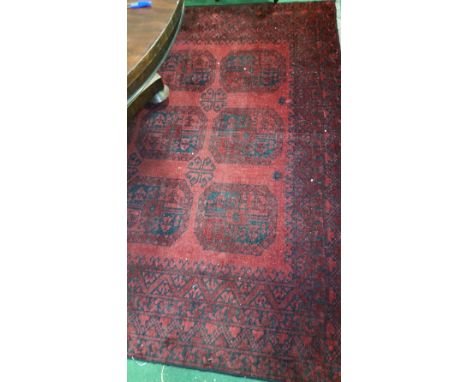 A Deep Red Ground Washed Afghan Carpet, full pile with Bokara design, approx. 3m x 2m.