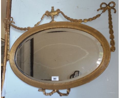 An Edwardian Oval Wall Mirror with Gilt Frame; with ribbon and swag decoration.