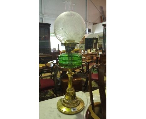 An Edwardian Brass Oil Lamp; with green glass reservoir.