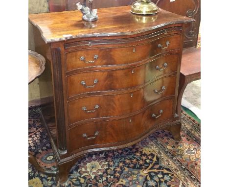 A Wonderful 20th Century Serpentine Fronted Mahogany Bachelors Chest with a brush slide above four drawers with brass handles
