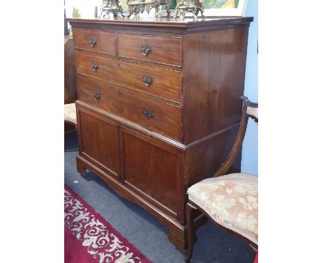 A 19th Century Cupboard; with two short and two long drawers above a pair of doors, on bracket feet.