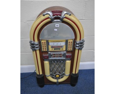 A MODERN 1950'S STYLE JUKEBOX, with a six disk, radio, FM, AM, and cassette function, optional lights, condition report: PAT 