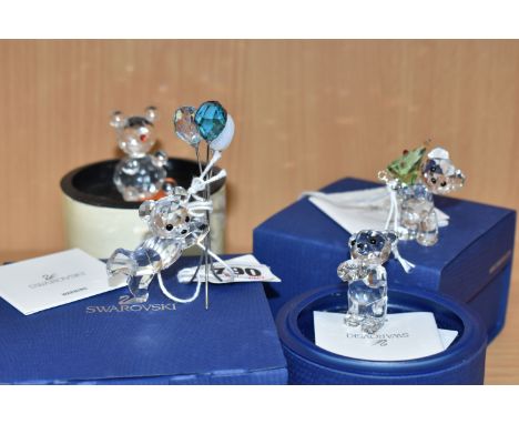 FOUR BOXED CUT CRYSTAL SCULPTURES to include three Swarovski Kris Bear sculptures comprising a 'Kris Bear with Christmas Tree