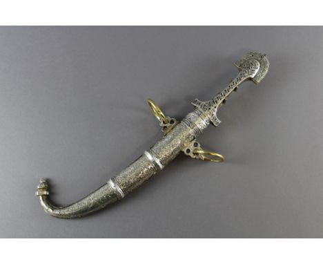 A Moorish white metal and silvered brass dagger, with shaped hilt and 23cm curved steel blade, with conforming scabbard, 40cm