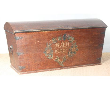 A large 19th century stained-pine dome-topped trunk, with iron furniture, initials MJD and date 1858 within a foliate wreath,