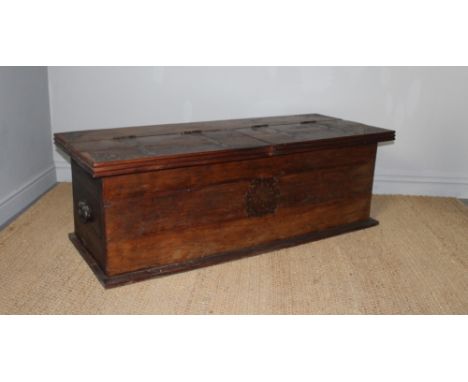 A 19th Century Eastern Tibetan hardwood trunk with twin lifting top inset with pierced metal ornament, twin side handles and 