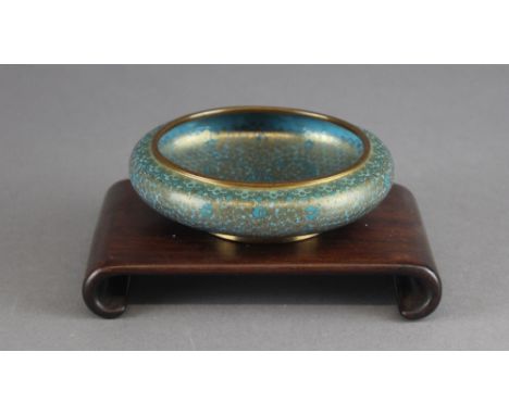 A Chinese cloisonne bowl, the blue ground with gold wire and gilded rim, the central field with a Shou character, 11.5cm diam