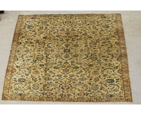 A Kashan carpet, woven with repeating floral sprays on a cream ground, 440cm x 260cm Minor isolated damage to pile, light sta