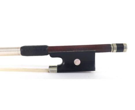 Nickel mounted violin bow stamped A. Lamy á Paris, the stick round, the ebony frog inlaid with pearl eyes and the ebony adjus