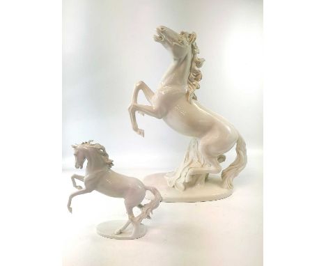 An Italian pottery lamp base, modelled in the white as a rearing horse, lacks all fittings, height 57cm, together with a Kais