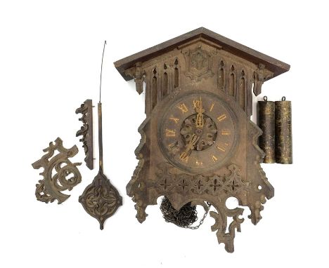 A Swiss Black Forest oak cuckoo wall clock, circa 1920, with Gothic pierced and applied tracery, height 35cm.