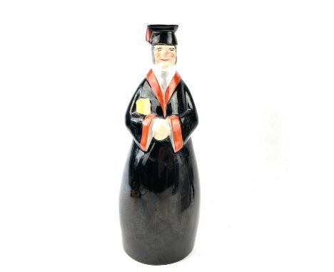 An Art Deco Robj, Paris, porcelain decanter/flask and cover, modelled as a School Teacher/Graduate, height 27cm.There is a ch