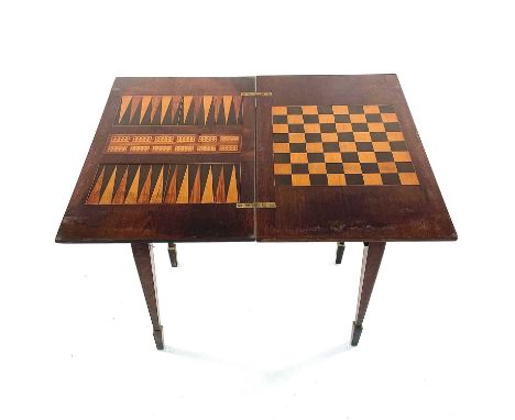 A late Victorian walnut and inlaid games and work table, stamped Jas Shoolbred &amp; Co, with swivel top inlaid for backgammo