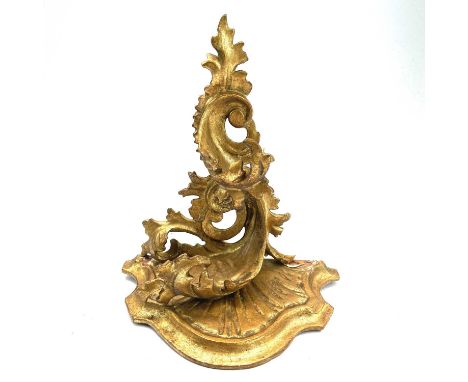 A giltwood carved wall bracket, Florentine, early 20th century, with rococo scroll leafy supports, height 22.5cm.There are tw