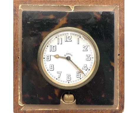 An 8 day travel clock, in a faux tortoiseshell surround, in an oak case, 12.5cm square.