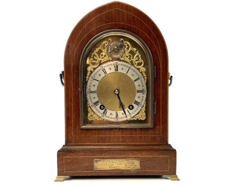 An early 20th century bracket clock by Winterhalder &amp; Hofmeier with arched brass dial in a lancet inlaid case, with brass