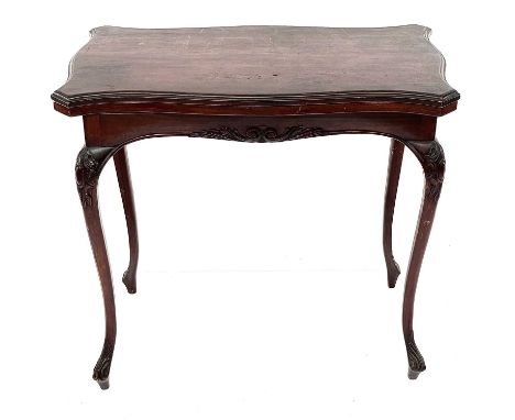 An Edwardian walnut fold top card table, with baized surface and raised on carved cabriole legs, height 72cm, width 80cm, dep