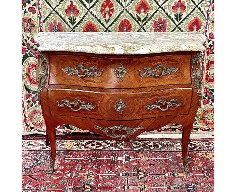 A French Louis XVI style kingwood, crossbanded and inlaid commode, circa 1900, of bombe form, with marble top and ormolu moun