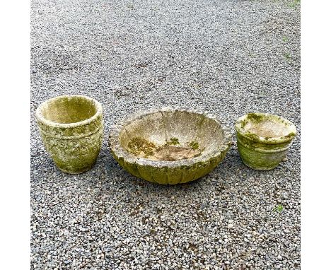 A large reconstituted stone floriform planter diameter 67cm together with two other reconstituted stone planters.