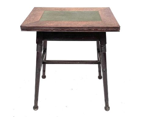 An Arts and Crafts oak card or games table, in the Liberty style, with fold-top on turned splay legs, height 75cm, width 64cm