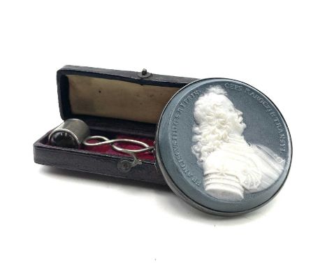 A miniature eye or magnifying glass, circa 1880, with white metal handle, leather cased, length 6.5cm, together with a jasper
