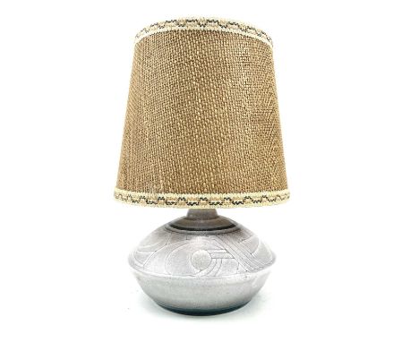 A Celtic pottery table lamp, of slightly compressed form, with incised decoration, height 12cm, with original shade.