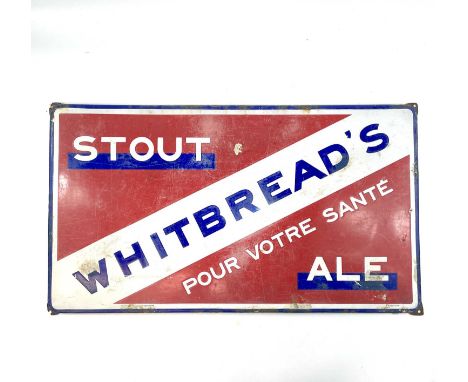 A French Whitbread's enamel advertising sign, titled 'Stout Ale Pour Votre Sante', stamped emailgraph and dated 1934, 46X82cm