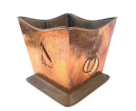 An Arts and Crafts copper planter, of tapered square section, with twin handles, repousse decorated with stylised flowerheads