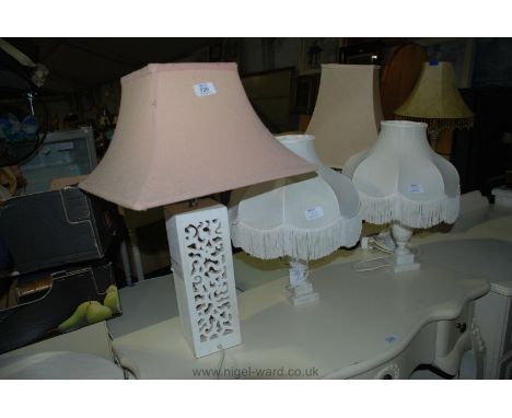 Pierced wooden table lamp with beige shade, and two white alabaster table lamps with white shades