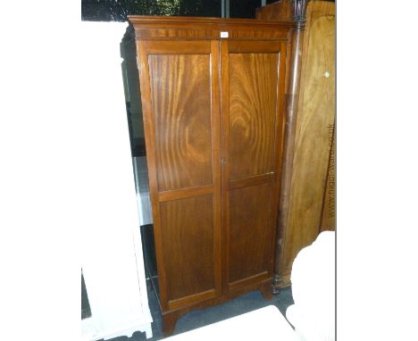 A small Mahogany Wardrobe on bracket feet, 69" tall.