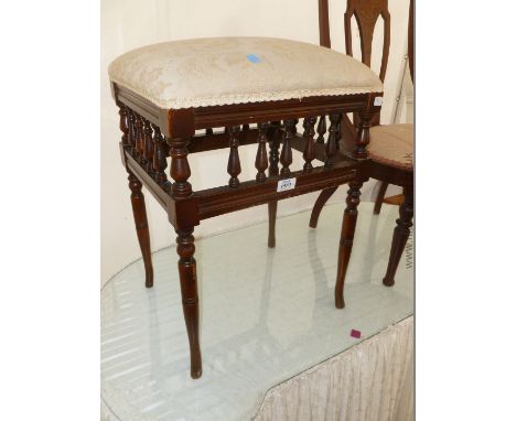 A Victorian upholstered Stool with bobbin turned detail.