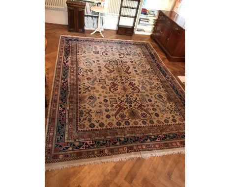 A light brown ground geometric and floral bordered Rug, 101'' x 135''
