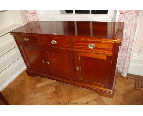 A reproduction Sideboard with three drawers over three cupboards, having drop ring handles, standing on bracket feet, 57'' wi