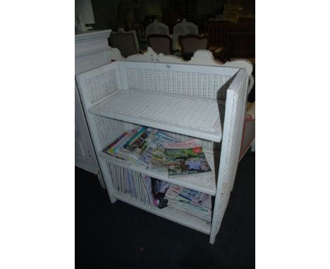 A Cane three shelf folding Bookcase with magazines, 36'' high x 30'' wide