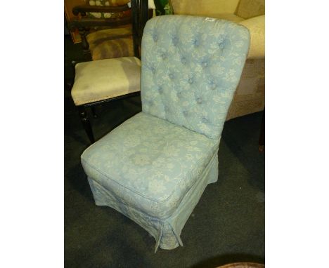A blue upholstered, button back Nursing Chair.
