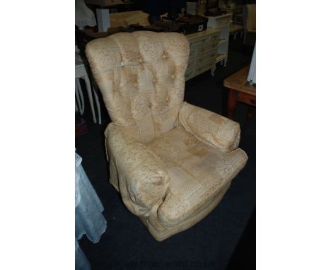 A modern beige/gold upholstered button back Chair