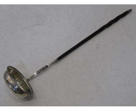 A George III period hallmarked silver toddy ladle; oval bowl and bright-cut decorated stem and twisted whale-bone handle (34.