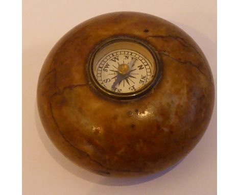 A late 19th/early 20th Century circular hardstone desk weight centrally set with a compass, 3.75cm diameter&nbsp;