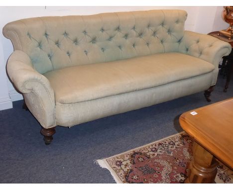 A large 19th century damask-upholstered walnut Chesterfield sofa; raised on short turned tapering fluted front legs terminati