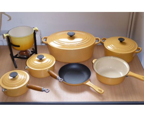 A good selection of Le Creuset enamelled kitchenware to include a large oval two-handled tureen, a smaller circular pot and c