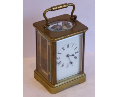 A late 19th / early 20th century brass and glass-sided carriage clock, white-enamel dial with Roman numerals, together with k
