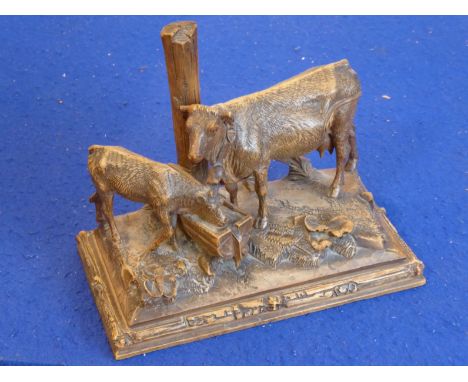 A late 19th / early 20th century Black Forest-style carving of a cow and calf drinking at a wooden trough (24cm wide)There is